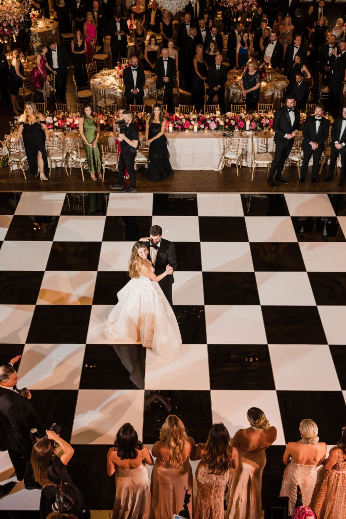 Chandelier lit ballroom with a checkerboard dance floor set up for a New Orleans event