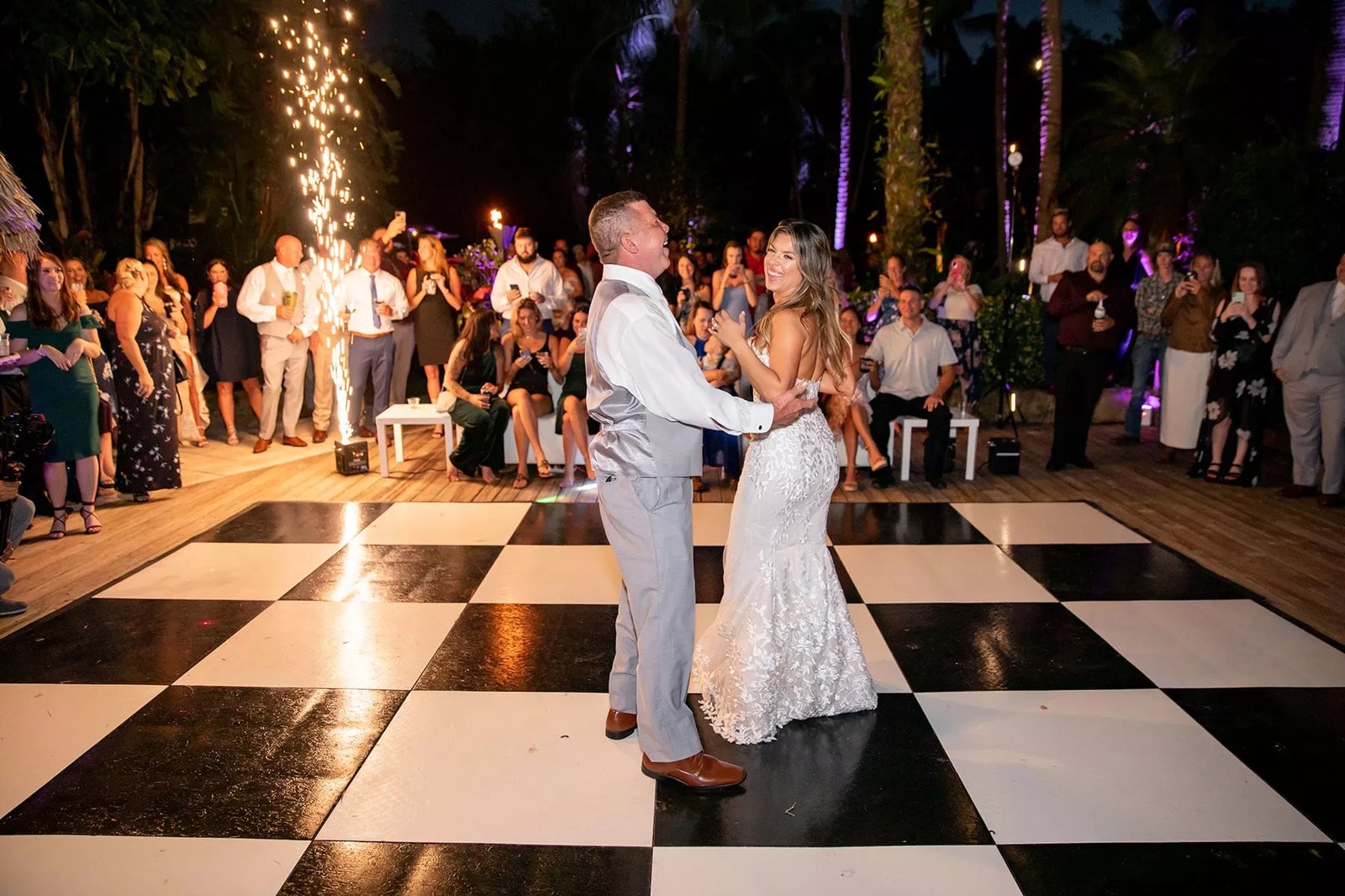 Couple sharing their first dance on a dance floor at an elegant indoor wedding reception in New Orleans